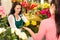 Cheerful flower shop florist customer buying yellow