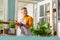 Cheerful flower shop owner smiling to his customers.