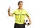 Cheerful football referee holding a ball and gesturing thumbs up