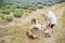 Cheerful friendly family is resting in village. The mother and children with cute little dog is playing