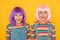 Cheerful friends in bright colorful wigs. Anime cosplay party concept. Happy childhood concept. Anime culture influence