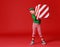 Cheerful funny child in Christmas elf costume with gifts on   red background