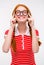 Cheerful funny young female fixing glasses and smiling