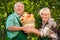 Cheerful gardeners holding apple basket.