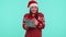Cheerful girl in Christmas Santa sweater getting present gift box, expressing amazement happiness
