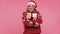 Cheerful girl in Christmas Santa sweater getting present gift box, expressing amazement happiness