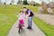 Cheerful girl and dad riding a bike