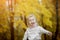 Cheerful girl enjoys autumn in the Park