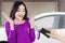 Cheerful girl get new car at garage