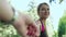 Cheerful girl leading boyfriend hand at fitness training in park. Follow me