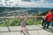 A cheerful girl on an observation deck in a sunny day over the view of Bergen, Norway