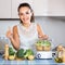 Cheerful girl preparing vegetables at steamer