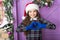 Cheerful girl in santa claus hat and gloves. winter holiday activity. season shopping. last preparation of small elf