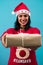 Cheerful girl smiling, giving a gift on a turquoise background