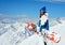 Cheerful girl snowboarder on the background of peaks snowy mountains