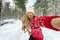 Cheerful girl among tall snow covered pines Christmas