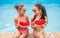 Cheerful girls eating watermelon near pool