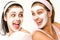 Cheerful girls having facial mask and laughing