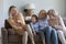 Cheerful girls and women of four different generations having fun