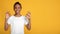 Cheerful glad teenage afro american girl in white t-shirt showing ok sign with hands