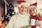 Cheerful glancing elderly twosome celebrating Christmas together