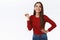 Cheerful good-looking sassy brunette girl in red sweater standing unbothered and carefree, holding hand on hip, laughing