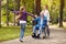 Cheerful grandchildren visiting disabled father in park