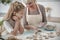 Cheerful granddaughter learning how to bake pastry