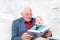 Cheerful grandfather and grandson sitting on the sofa