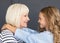 Cheerful grandmother and her granddaughter looking at each other