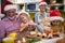 Cheerful grandparent enjoying with grandchildren in Xmas meal preparation in the kitchen. Christmas, family, together