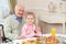 Cheerful grandparent has lunch with a child