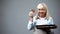 Cheerful granny showing chocolate biscuits, cooking school, family traditions