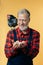 Cheerful grey-haired man trying to protect chickens