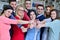 Cheerful group of students smiling at camera with thumbs up, success and learning concept