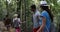 Cheerful Group Of Tourists Trekking Forest Path On Hike, Young People With Backpacks Hiking Together