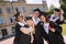 Cheerful groupmates taking selfies after their graduation.