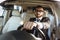 cheerful handsome driver in suit and glasses