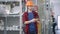 Cheerful handsome man taking selfie in hardware store. Positive smiling brunette millennial in hard hat taking photo for