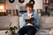 A cheerful handsome teenage boy learns English using a dictionary. A student is preparing for a college exam