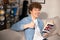 A cheerful handsome teenage boy learns English using a dictionary. A student is preparing for a college exam