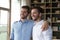 Cheerful handsome young adult twin brothers posing for shooting together