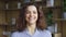 Cheerful happy hispanic young adult 20s woman looking at camera, headshot.