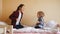 Cheerful and happy teenage girl jumping on bed with her little toddler brother