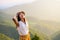 Cheerful hiker on a mountain at sunset