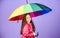 Cheerful hipster child in positive mood. rain protection. Rainbow. happy little girl with colorful umbrella. little girl