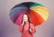 Cheerful hipster child in positive mood. Small girl in raincoat. autumn fashion. rain protection. Rainbow. happy small