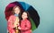 Cheerful hipster children, sisterhood. rain protection. Rainbow. autumn fashion. happy little girls with colorful