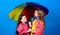 Cheerful hipster children, sisterhood. rain protection. Rainbow. happy little girls with colorful umbrella. family bonds