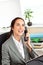 Cheerful hispanic businesswoman talking on phone